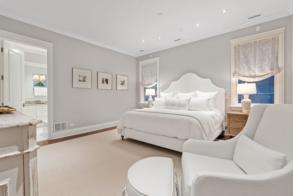 Photo of a primary bedroom with furniture and decor