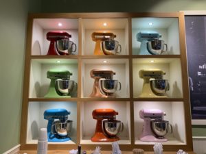 Nine brightly lit, colorful mixers sit in a nine cube built into the wall at Stan's Donuts & Coffee.